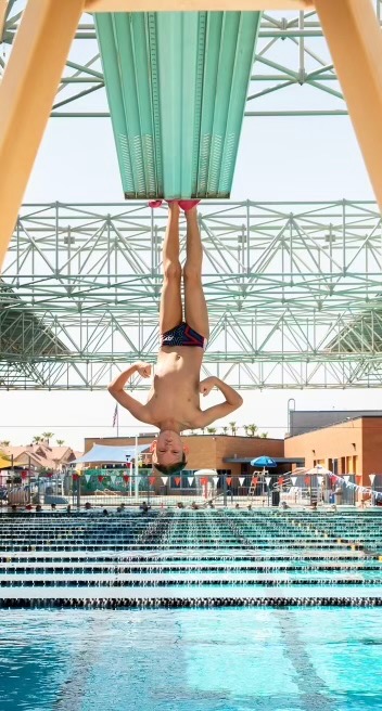 Diver hanging off of 3 meter springboard